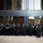 police officers in uniform in front of office building