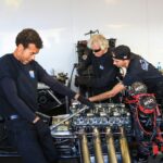 mechanics working on engine