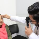 optometrist examining a patient